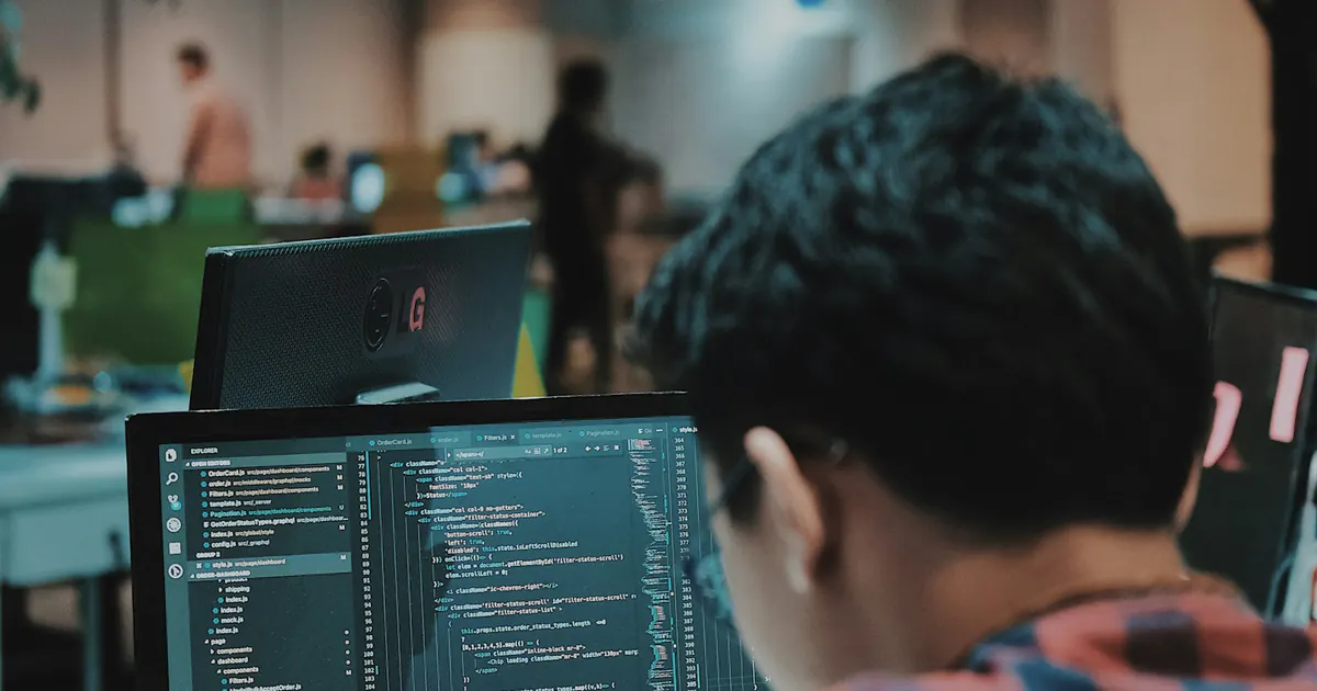 Profissional escreve código em um computador no escritório.