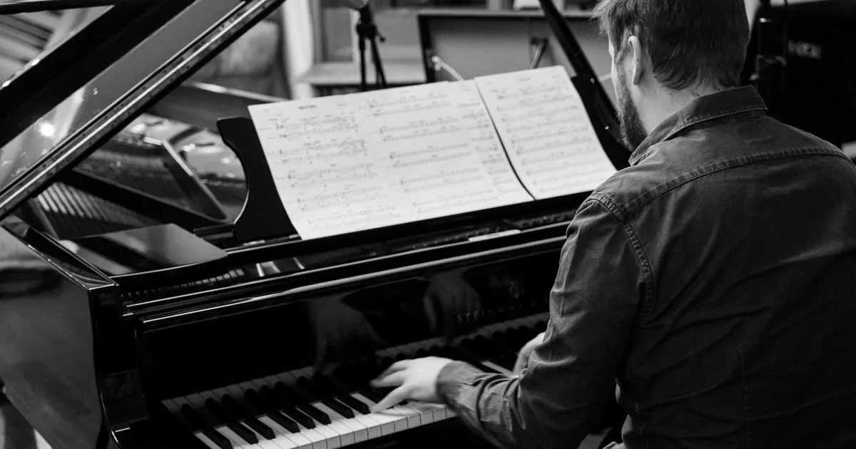 Músico toca piano em um estúdio de gravação.