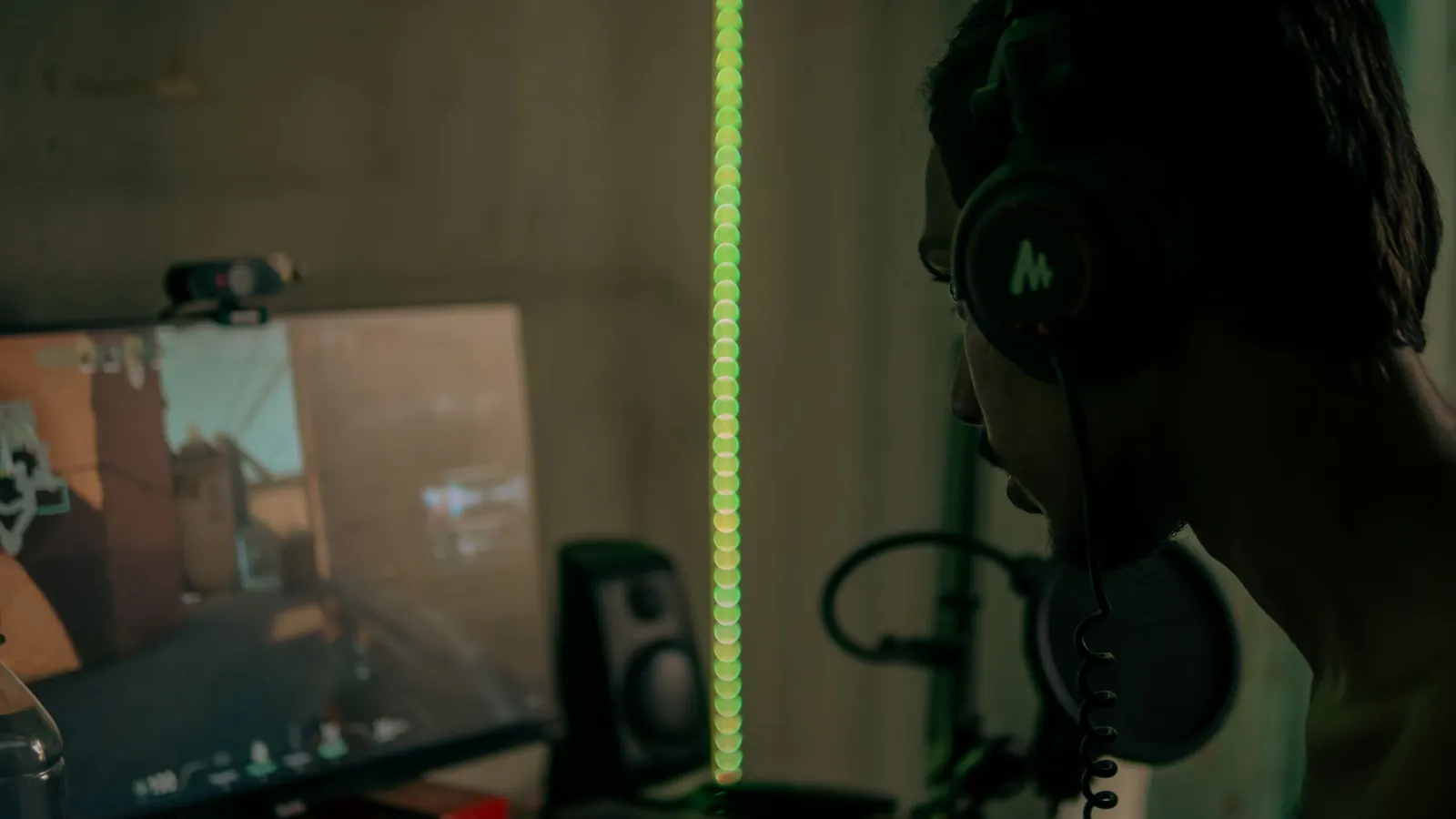Jogador usa headset enquanto joga em um computador.
